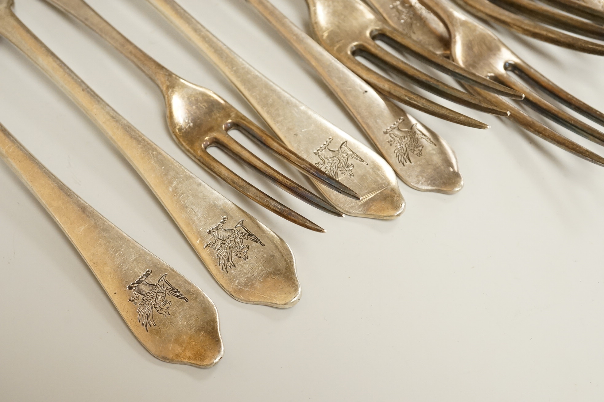 A set of seven late Victorian silver dog-nose three pronged table forks and ten matching dessert forks, all with engraved crest, Francis Higgins’s III, London, 1889, table fork length 19.5 cm, 34.5 oz.